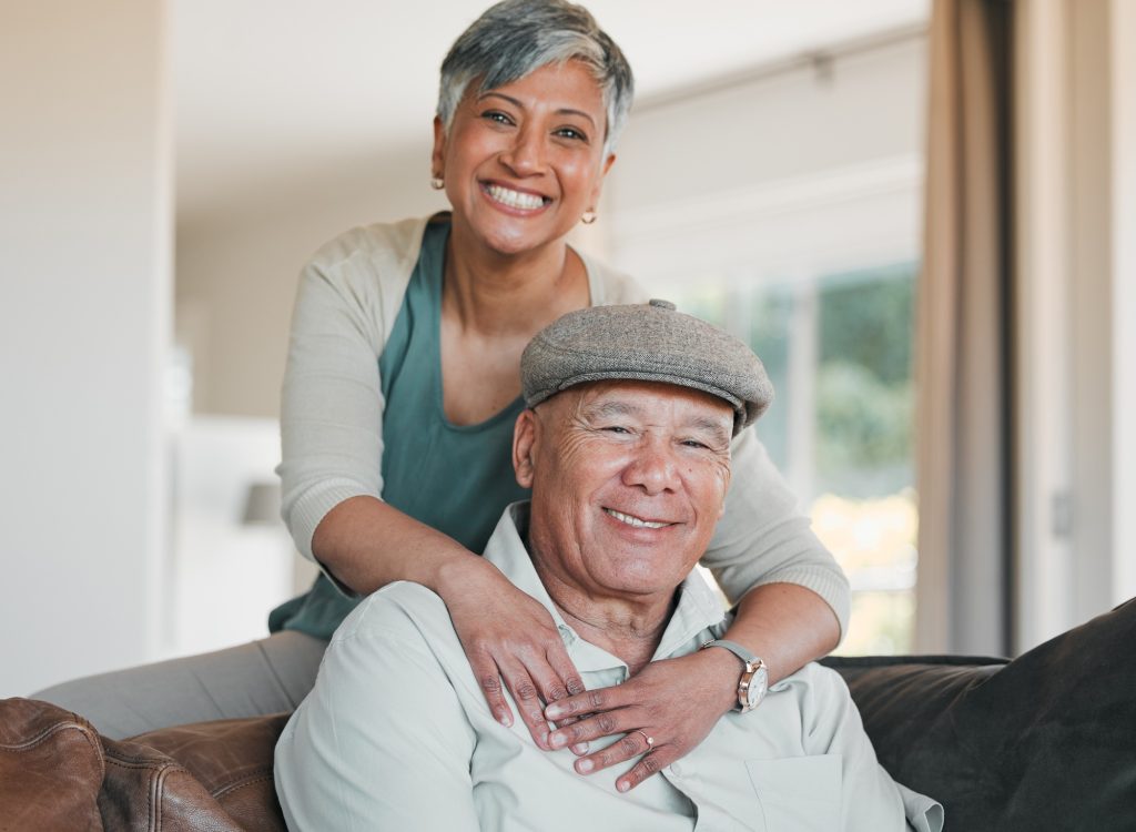 Senior couple, portrait and smile in home for retirement, marriage commitment and loyalty to partne